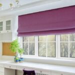Interior of room, workplace near window, furniture, desk, blue roman blind, wall shelves